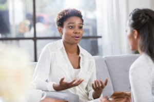 Woman motions while talking to therapist