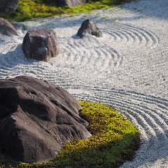 Zen rock garden with raked-over gravel 